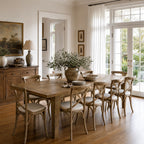 Renwick Extendable Dining Table 3.1 in solid mango wood with rich grain, surrounded by chairs in a sunlit dining room.
