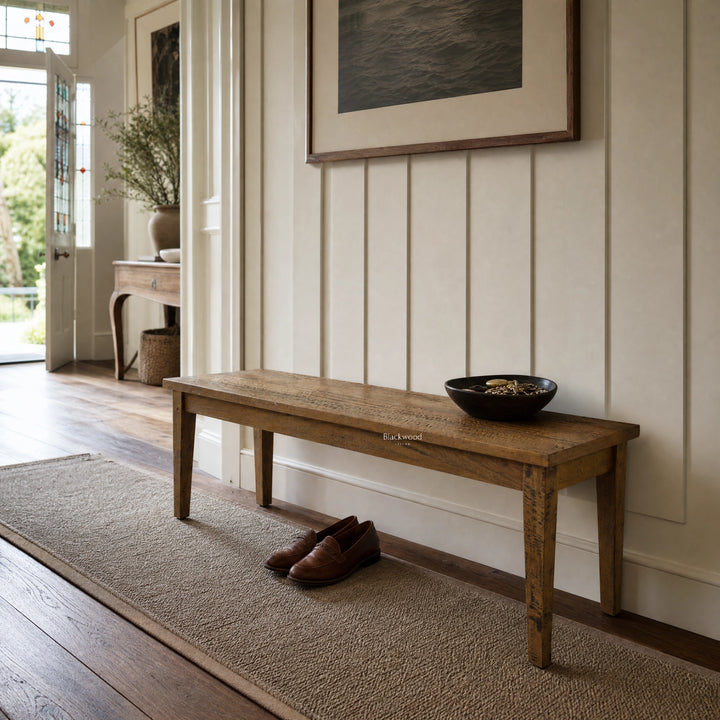 Renwick Bench Seat in a sunlit entryway, crafted from solid mango wood with clean lines and rich grain.