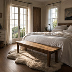 Renwick Bench Seat 170cm in solid mango wood with natural grain at the foot of a bed in a sunlit bedroom.
