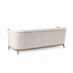 Windsor Sofa in parchment fabric with chalk-wash oak frame and curved silhouette.
