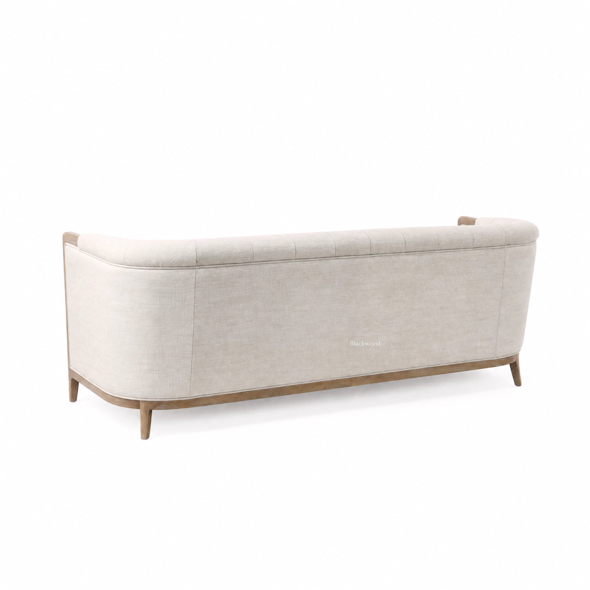 Windsor Sofa in parchment fabric with chalk-wash oak frame and curved silhouette.