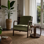 Java Occasional Chair with dark oak frame and Rainforest green velvet upholstery in a sunlit living room.