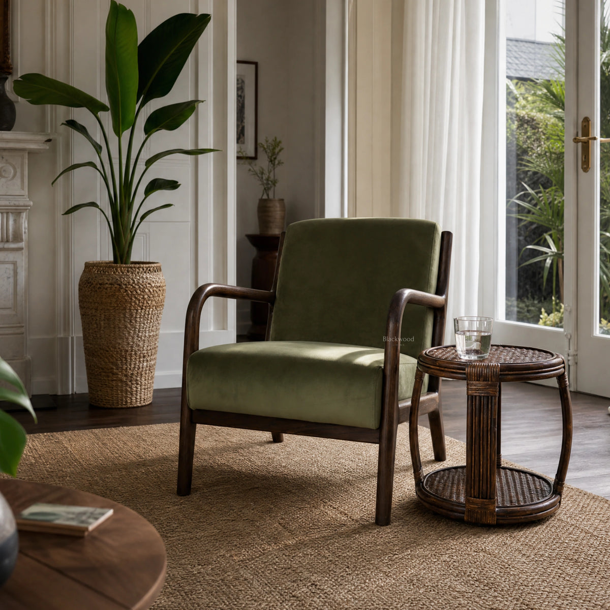 Java Occasional Chair with dark oak frame and Rainforest green velvet upholstery in a sunlit living room.