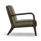 Java Occasional Chair with a dark oak frame and deep green velvet upholstery.