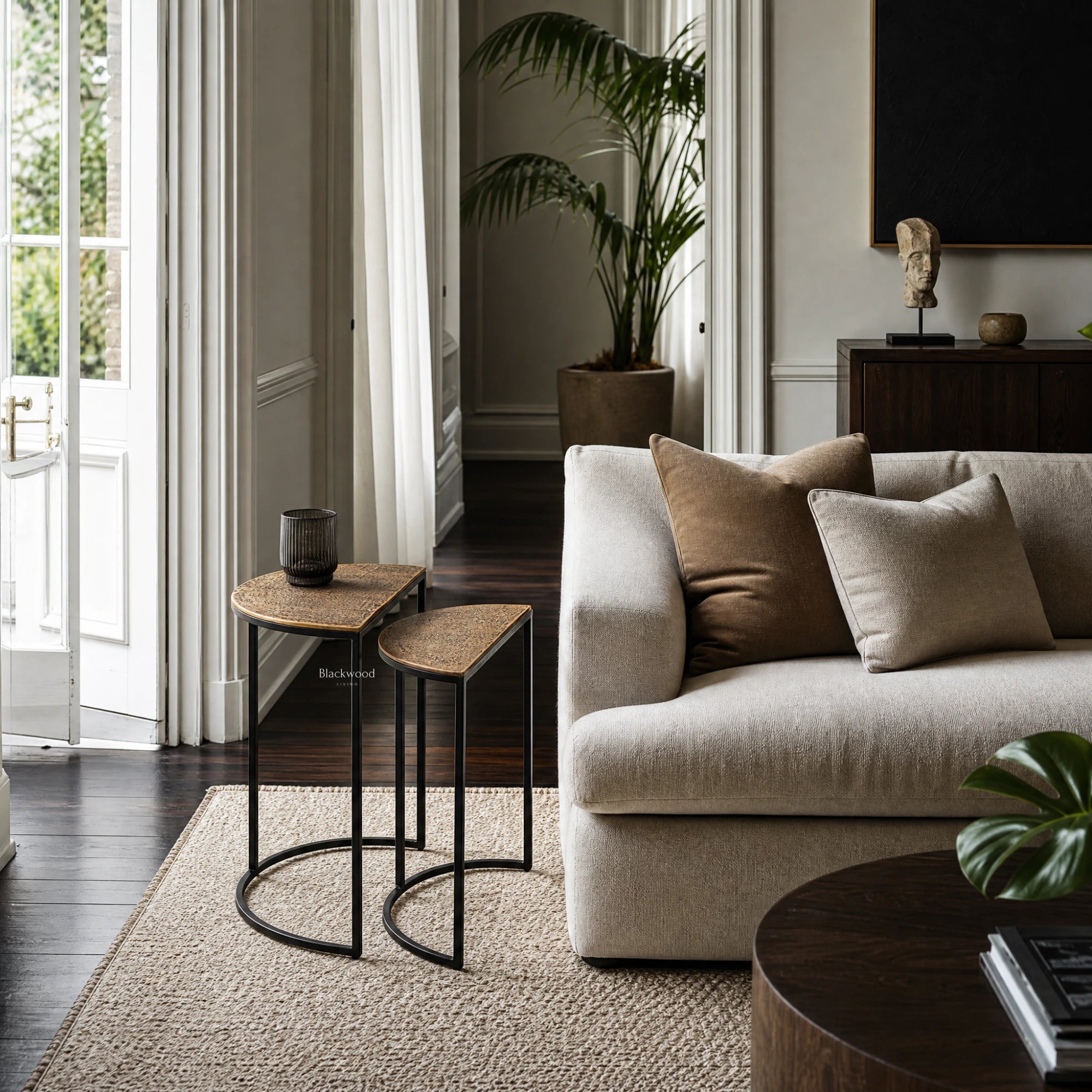 Agra Side Tables Set/2 with textured wood tops and black metal frames beside a beige sofa in a modern living room.