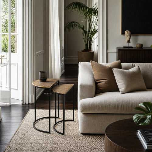 Agra Side Tables Set/2 with textured wood tops and black metal frames beside a beige sofa in a modern living room.