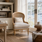 Bayview Lounge Chair with ash frame, natural rattan weave, and 100% linen upholstery in a coastal living room.