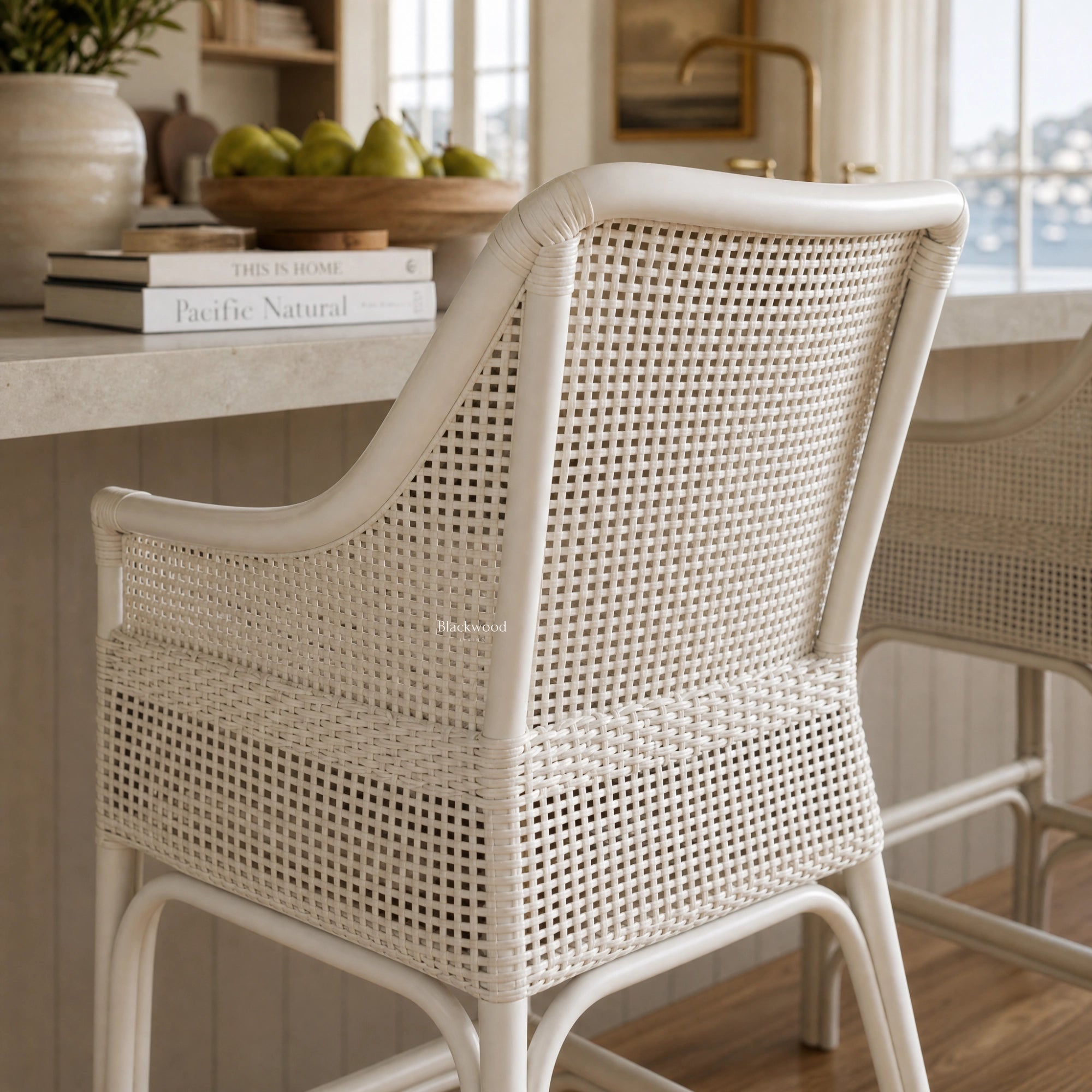 Singapore Counter Stool - White with woven rattan back and curved silhouette for coastal kitchen seating.