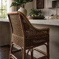 Singapore Counter Stool in coffee finish, woven rattan with a curved silhouette in a coastal kitchen setting.