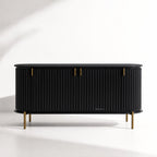 Valmont Curved Buffet crafted from solid mango wood with a curved silhouette, fluted detailing and aged brass feet.