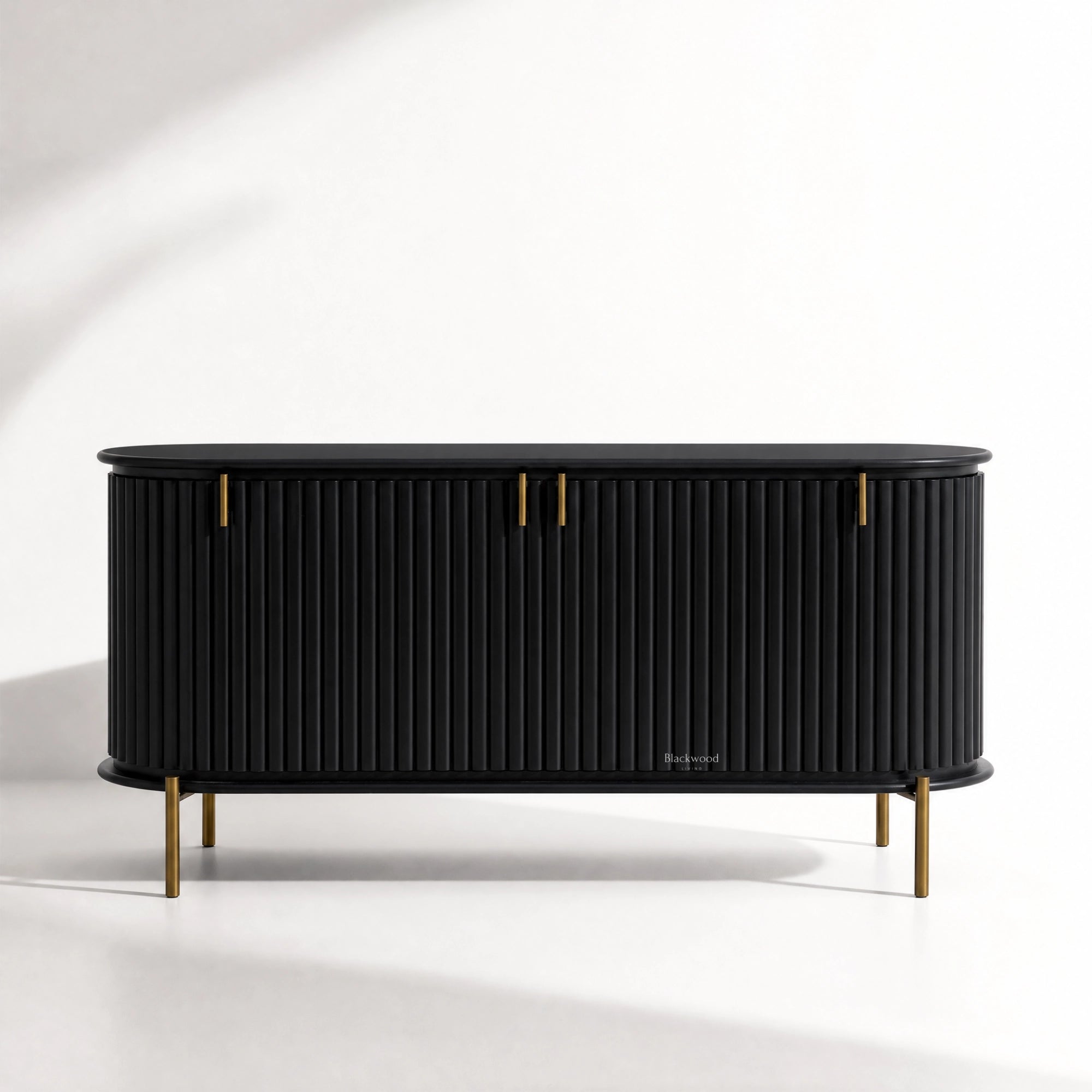 Valmont Curved Buffet crafted from solid mango wood with a curved silhouette, fluted detailing and aged brass feet.