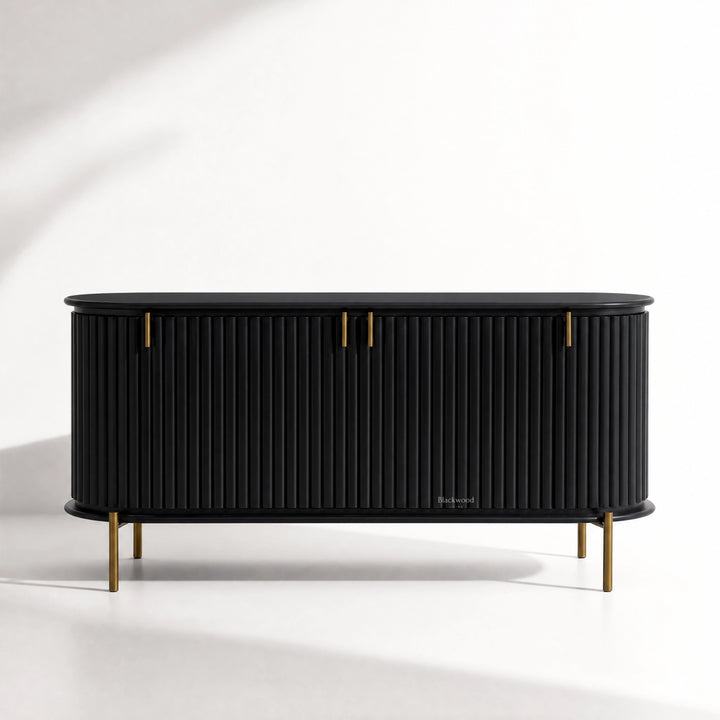 Valmont Curved Buffet crafted from solid mango wood with a curved silhouette, fluted detailing and aged brass feet.