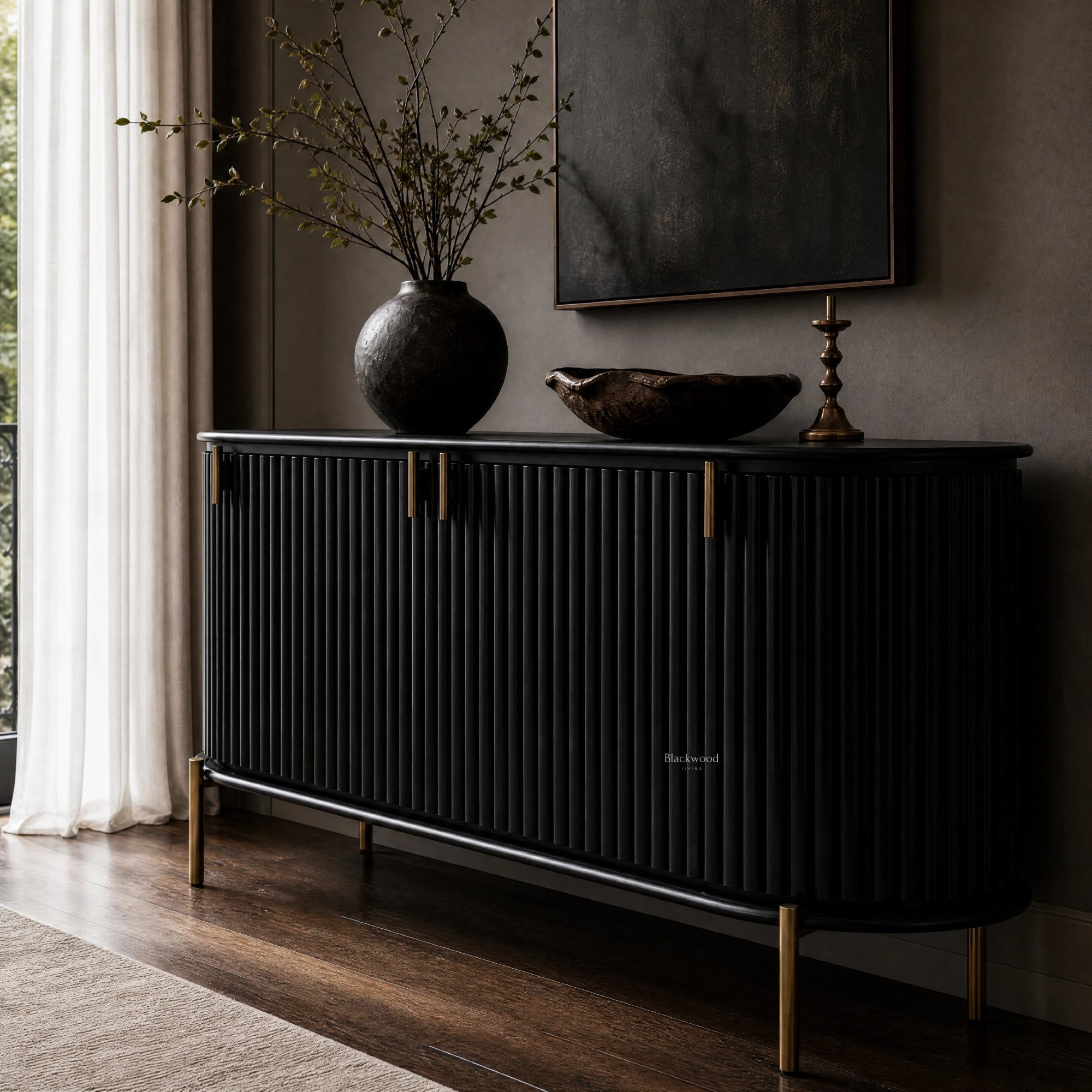 Valmont Curved Buffet in black with curved silhouette, fluted detailing, mango wood warmth, aged-brass feet.