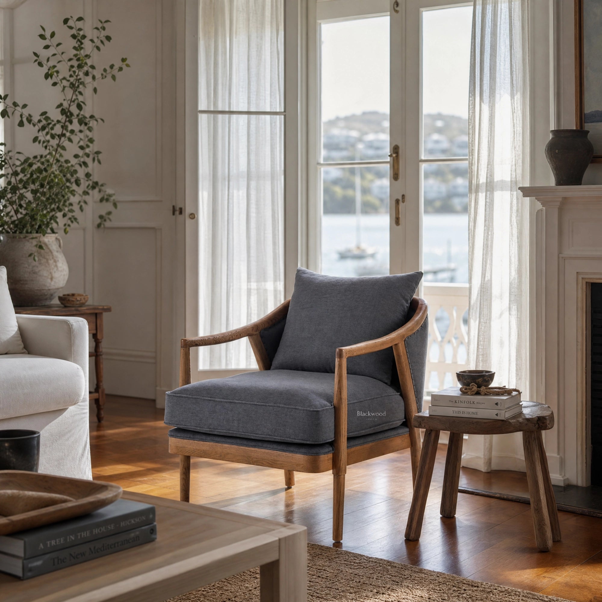 Westport Occasional Chair in Atlantic Blue with a solid timber frame and oak arms in a light coastal living room.