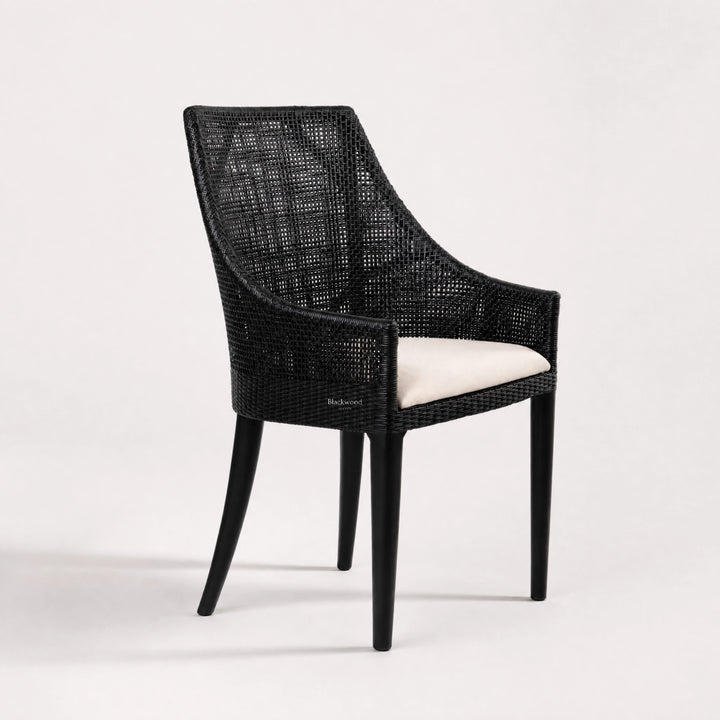 Barbados Dining Chair: black woven rattan with curved back and beige cushioned seat.