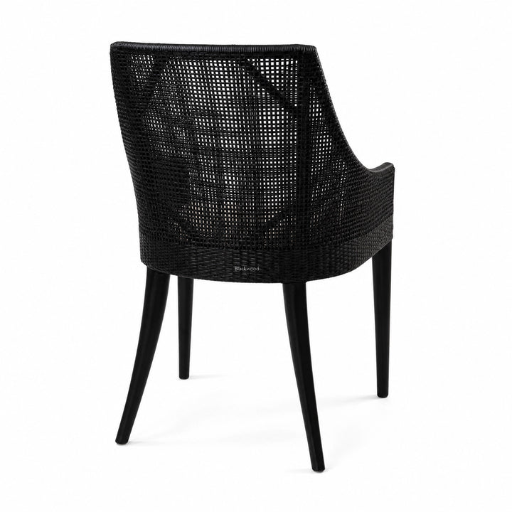 Barbados Dining Chair in black woven rattan with a curved back and arms for plantation-inspired dining.