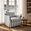 Newport Armchair in Mariner Blue Stripe with cushioned seat and striped linen-blend slipcover in a coastal living room.