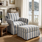 Newport Armchair in Mariner Blue Stripe with striped linen-blend slipcover and matching ottoman in a coastal lounge.