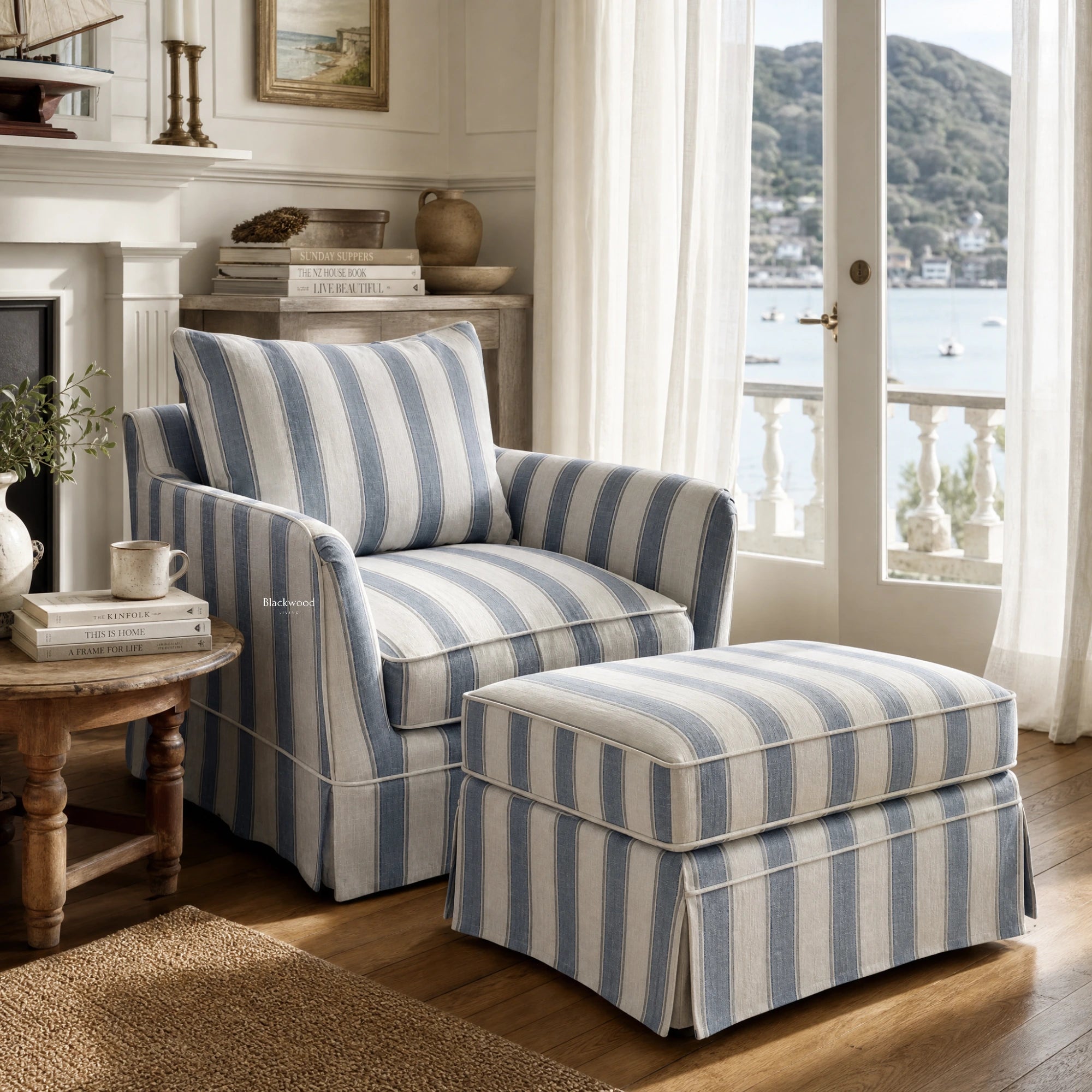 Newport Armchair in Mariner Blue Stripe with striped linen-blend slipcover and matching ottoman in a coastal lounge.