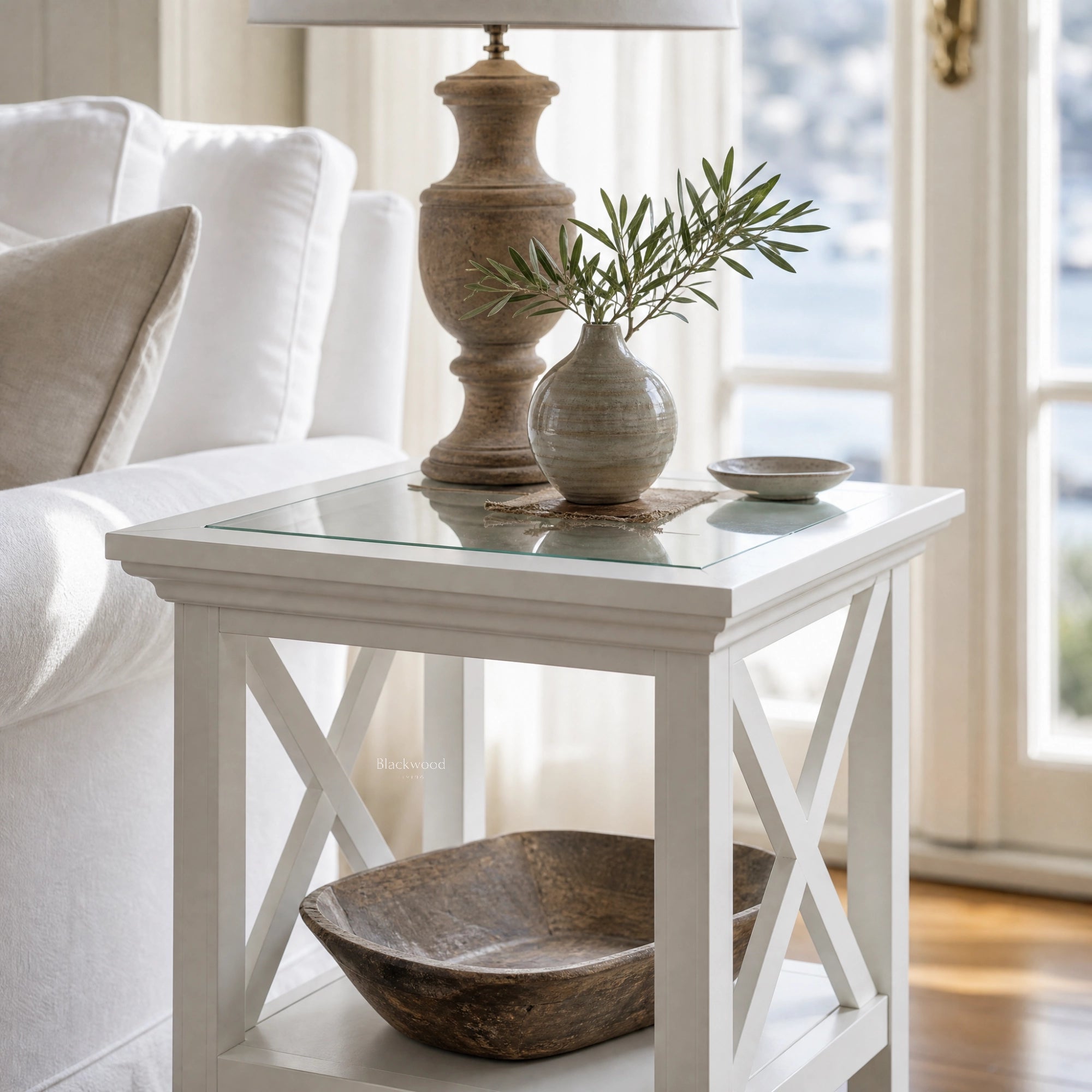 Newport Side Table with glass top and white cross-legged frame in a bright Hamptons-style living room.