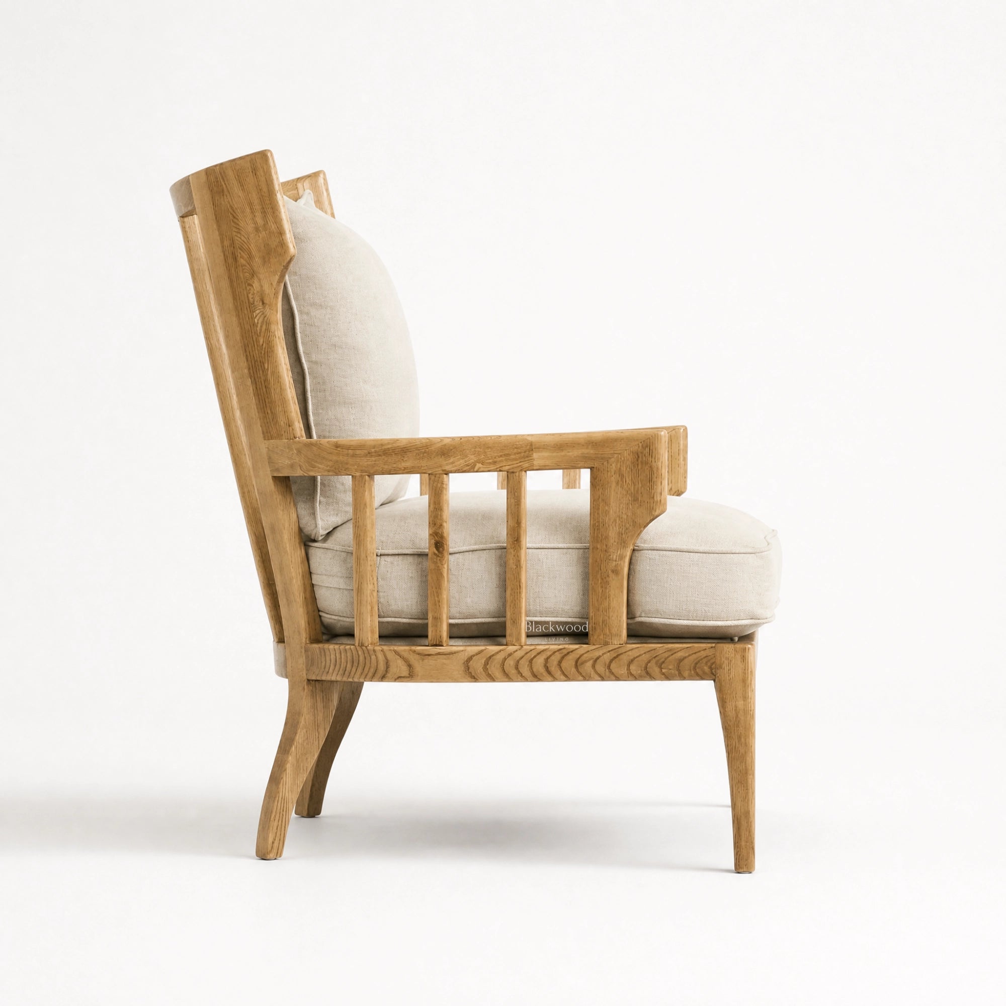 Sorrento Lounge Chair with relaxed elegance, warm oak frame, and light linen upholstery.
