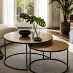 Harrington Coffee Table Set/2 with textured antique brass aluminium tops and black metal frames in a sunlit living room.