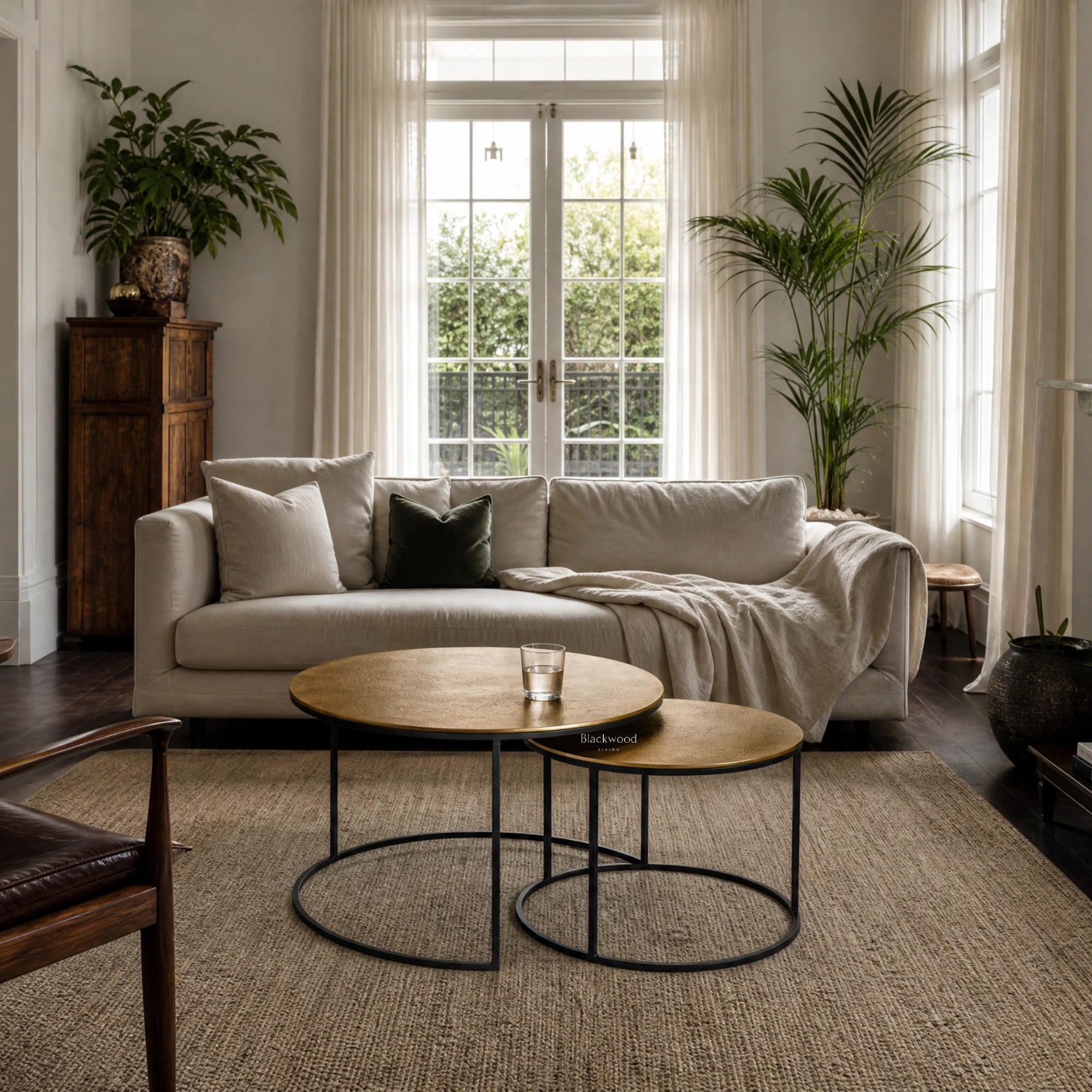 Harrington Coffee Table Set/2: two circular tables with textured antique-brass tops on black metal bases.