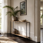 Assam Console Table, aluminium with antique brass finish and matt black frame, in a refined living space.