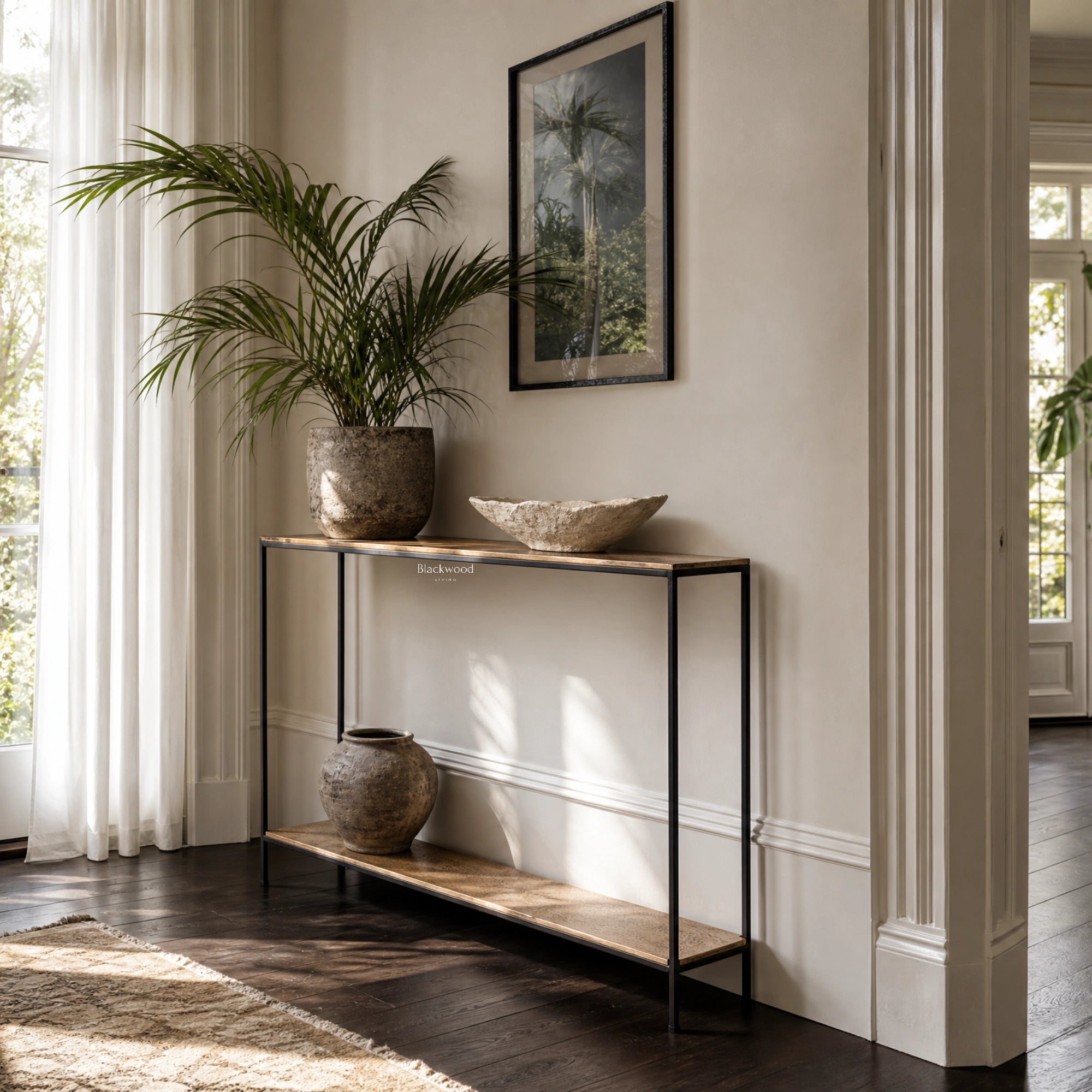 Assam Console Table, aluminium with antique brass finish and matt black frame, in a refined living space.