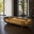 Madras Footed Bowl in antique brass finish, textured aluminium, on dark wood dining table.