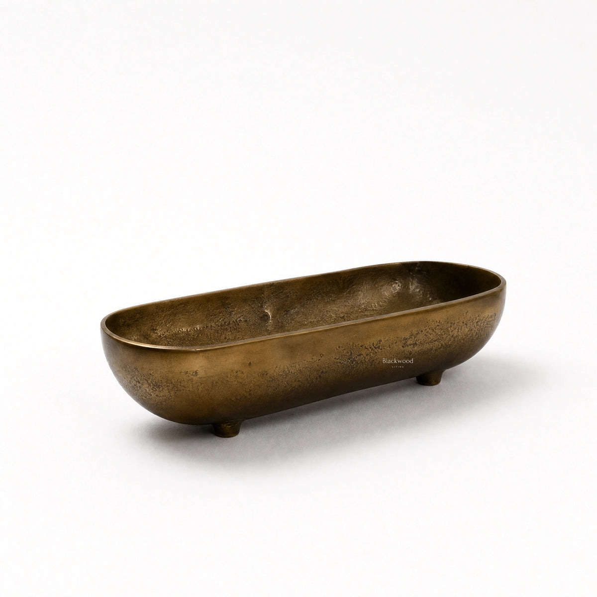 Madras Footed Bowl in antique brass finish, long oval aluminium bowl with textured surface and small feet.