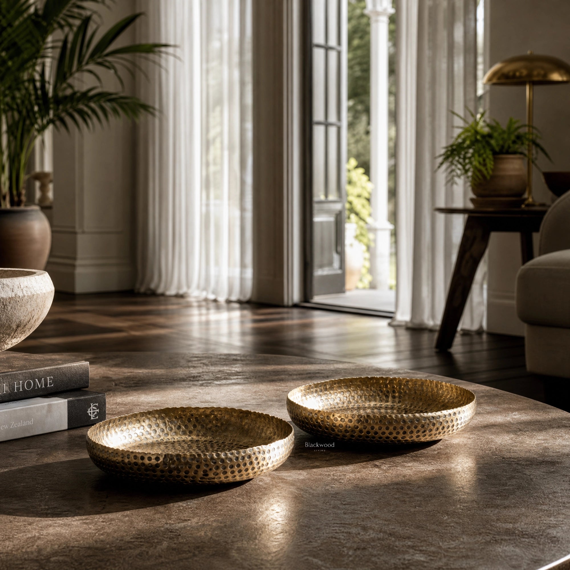 Madras Decorative Bowls Set/2: hammered aluminium bowls with brass finish in a stylish living room.