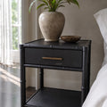Rangoon Bedside Table - Black with a speckled vase holding a green plant and a decorative bowl.