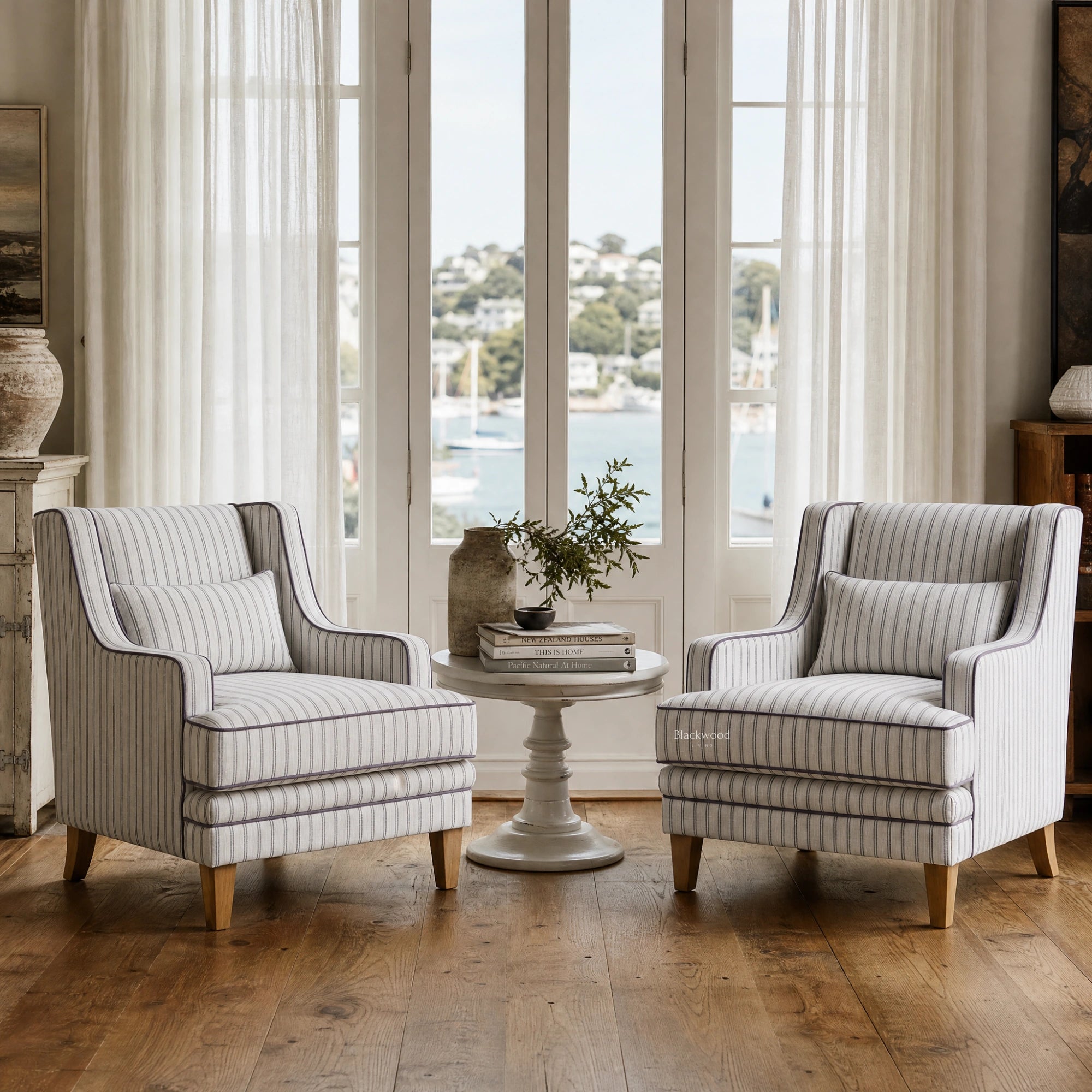 Anchorage Lounge Chairs Newport Stripe in a bright coastal living room with striped upholstery around a round table.