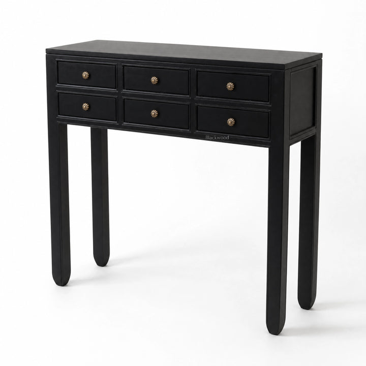 Black Penang hall table with slender profile, six drawers, and warm-toned metal handles for entryway or living space.