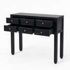 Black Penang hall table with slender legs and six open drawers featuring warm-toned metal handles for entryway storage.