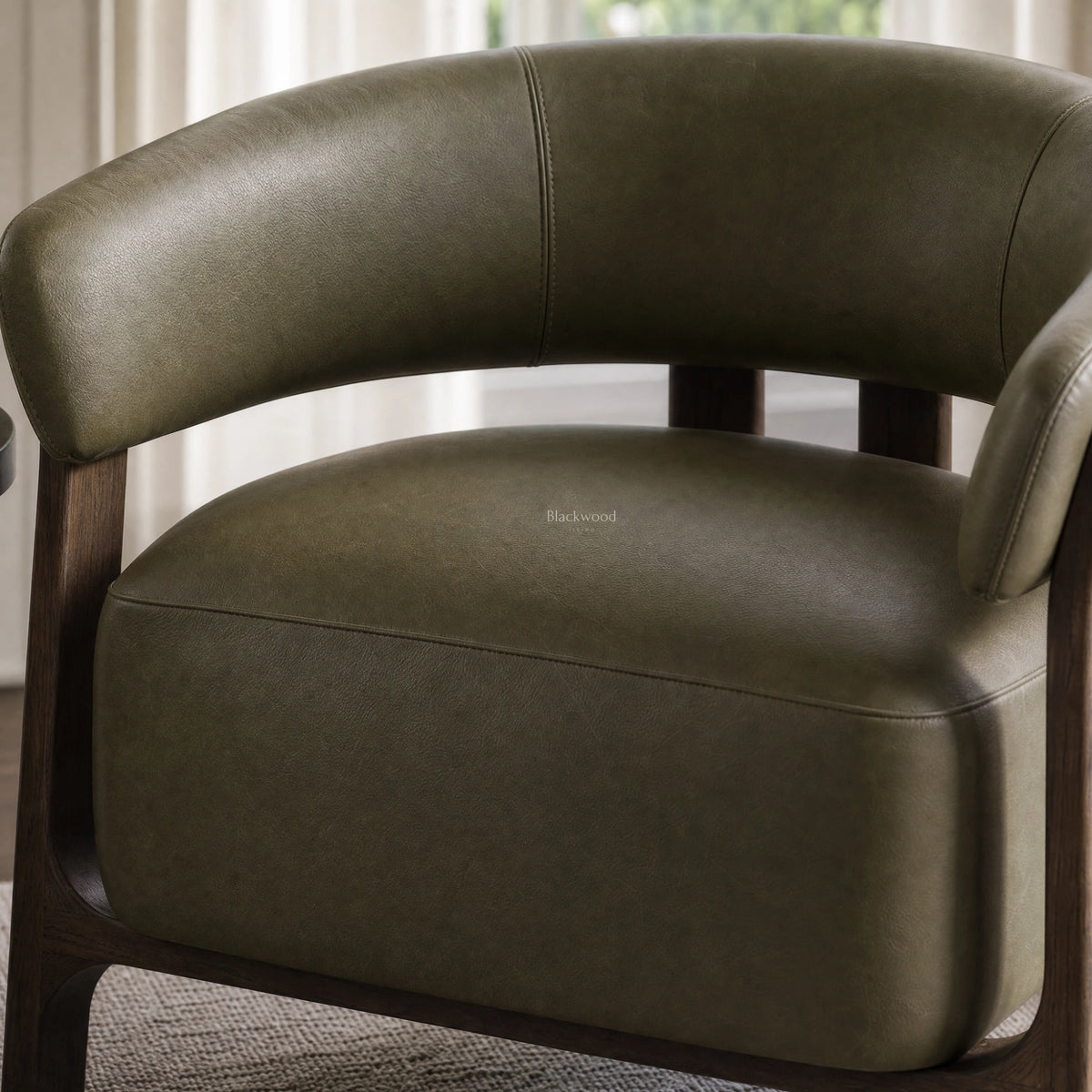 Olive top grain leather chair with a curved back and solid ash timber frame.