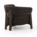 Rear view of black leather Alderton armchair featuring a curved back and solid ash timber frame with sturdy legs.