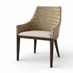 Woven rattan dining chair with solid timber frame, armrests, and cushioned seat in relaxed plantation style.