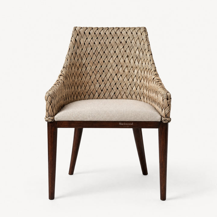 Plantation-style dining chair with hand-woven rattan back, solid timber frame, and cushioned seat.