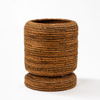 Small woven banana leaf planter with rounded form and base. Adds natural texture and tropical warmth to home decor.