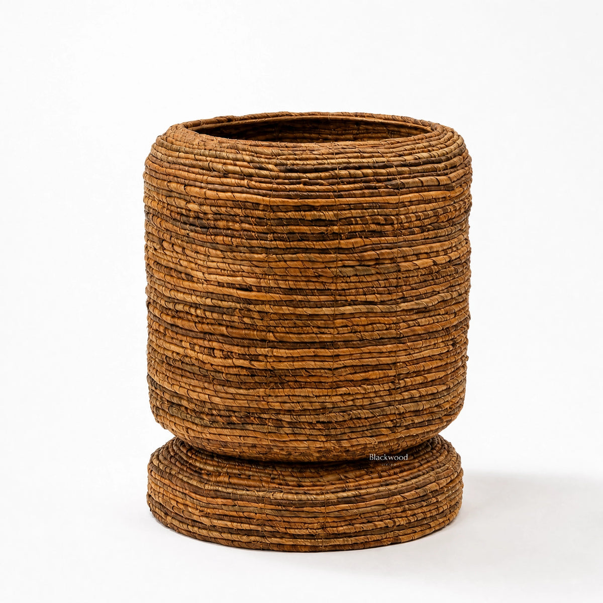 Small woven banana leaf planter with rounded form and base. Adds natural texture and tropical warmth to home decor.