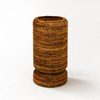 Large woven Ceylon planter with rounded form and textured banana leaf construction, featuring a pedestal base for tropical home decor.