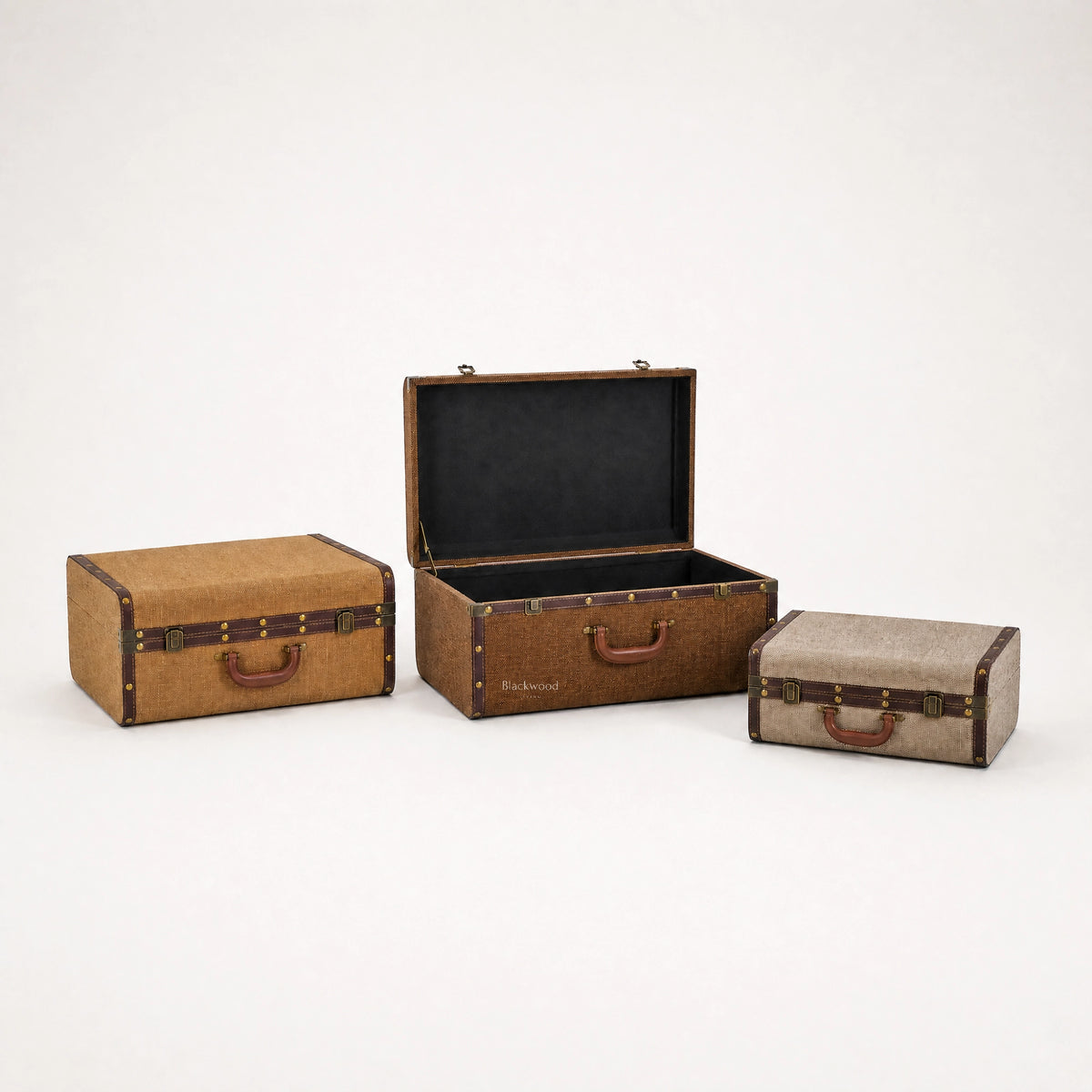 Vintage travel trunk nesting set of three with woven texture, PU trim, iron hardware, and concealed storage.