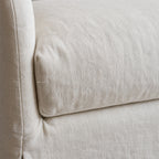 Close-up detail of the Monique Linen Slipcover Sofa showing soft curved arm and natural 100% linen texture.