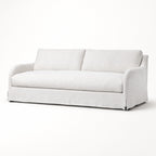 Monique Linen Slipcover Sofa with softly curved arms, loose silhouette, and full-length linen skirt.