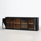 Dark black sideboard with arched doors open to reveal warm timber interior shelves and architectural design.