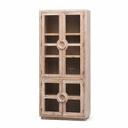 Tall coastal elm cabinet with glazed doors and distinctive circular nautical-style handles, bringing maritime character to interior spaces.