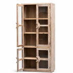 Tall elm Capstan Cabinet with glazed doors, nautical circular handles, and open shelving displaying coastal character.