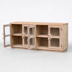 Wide elm sideboard with glass doors open to show interior shelves and a weathered coastal finish.